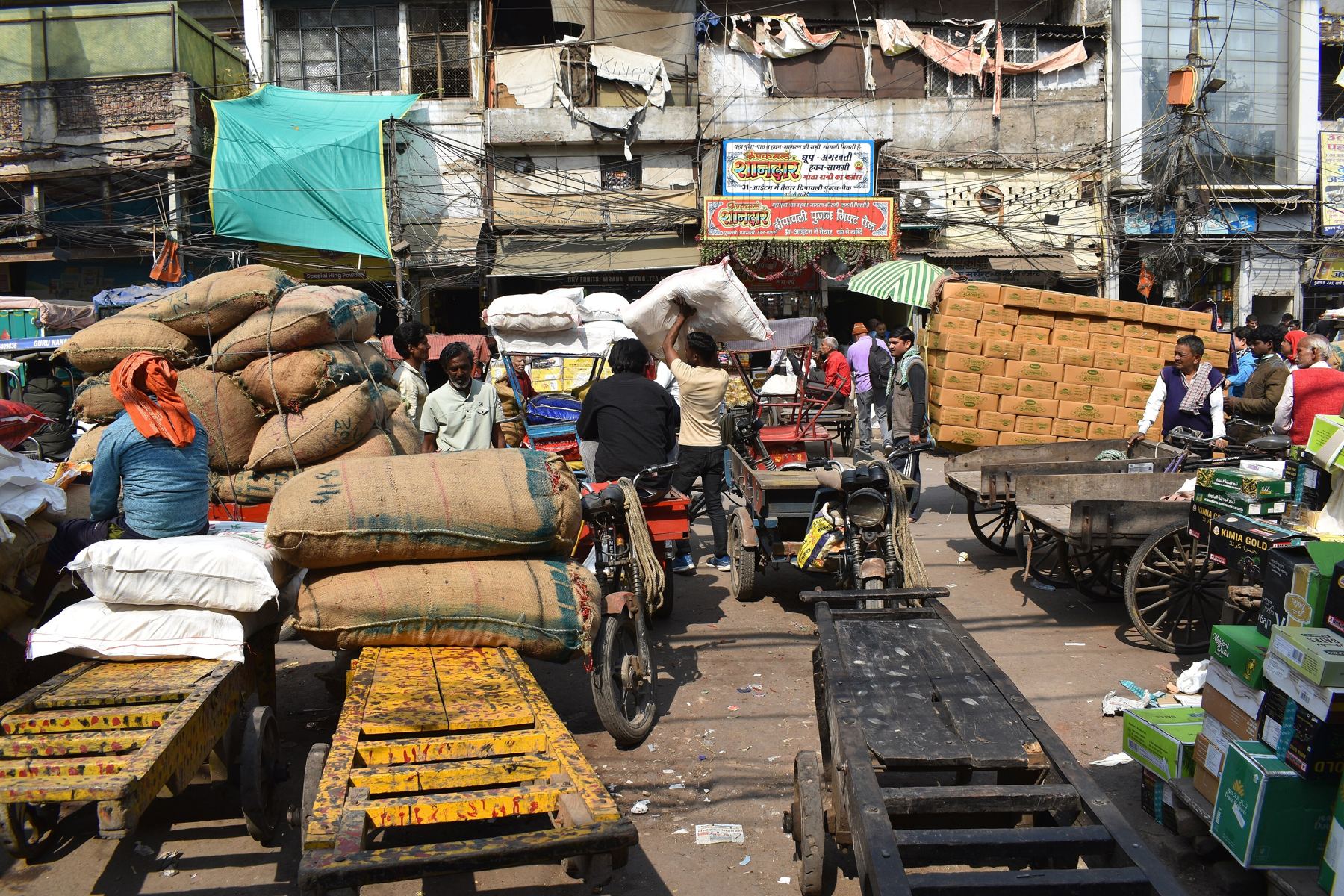 Grain sacks being moved in Old Delhi's wholesale market